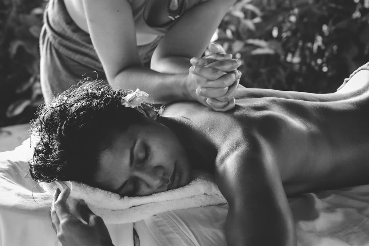 Private luxury couples massage suite with rose petals and romantic candlelit ambiance